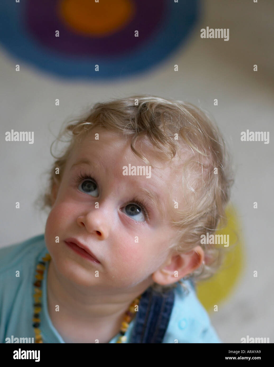 baby with inquiring look upwards Stock Photo Alamy