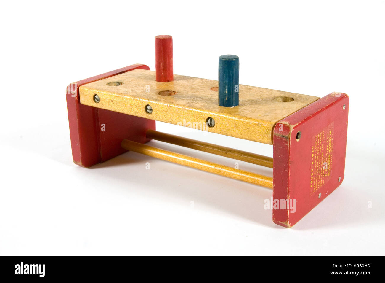 pound the pegs in the holes is the name of the game for this toy Stock Photo