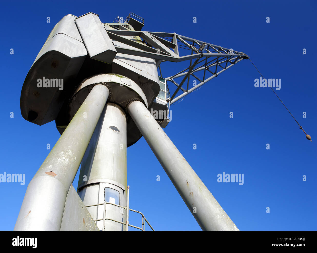 Steel leviathan: a huge crane looms large against a flawless sky like a towering mechanical alien Stock Photo