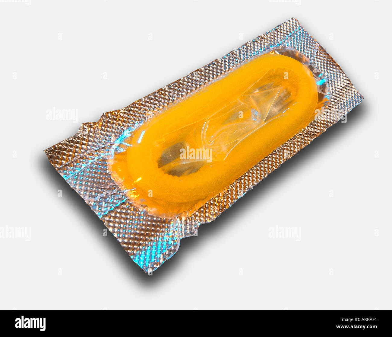 SINGLE YELLOW CONDOM IN FOIL WRAPPER ON WHITE BACKGROUND Stock Photo - Alamy