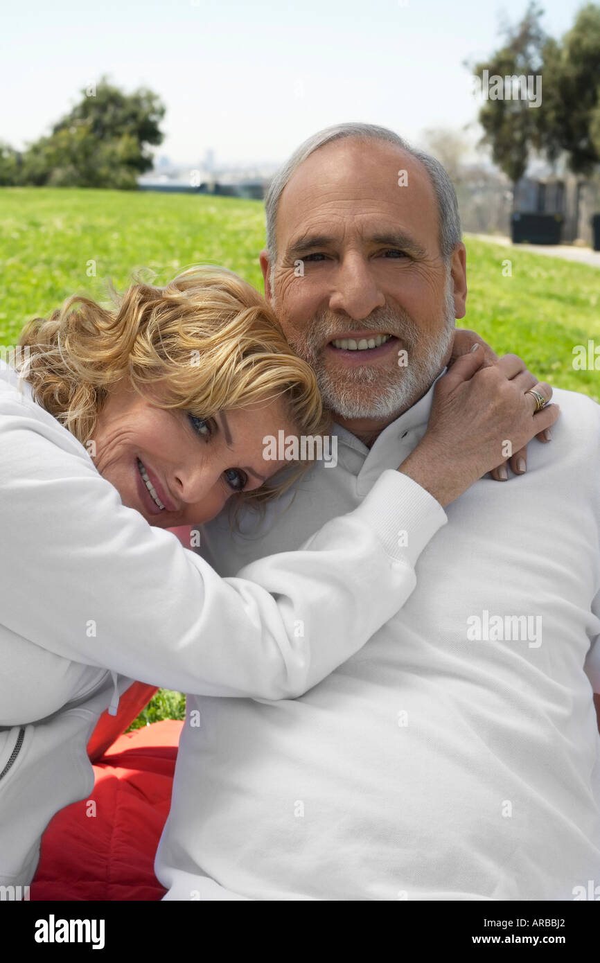 Couple Sitting Outdoors Stock Photo