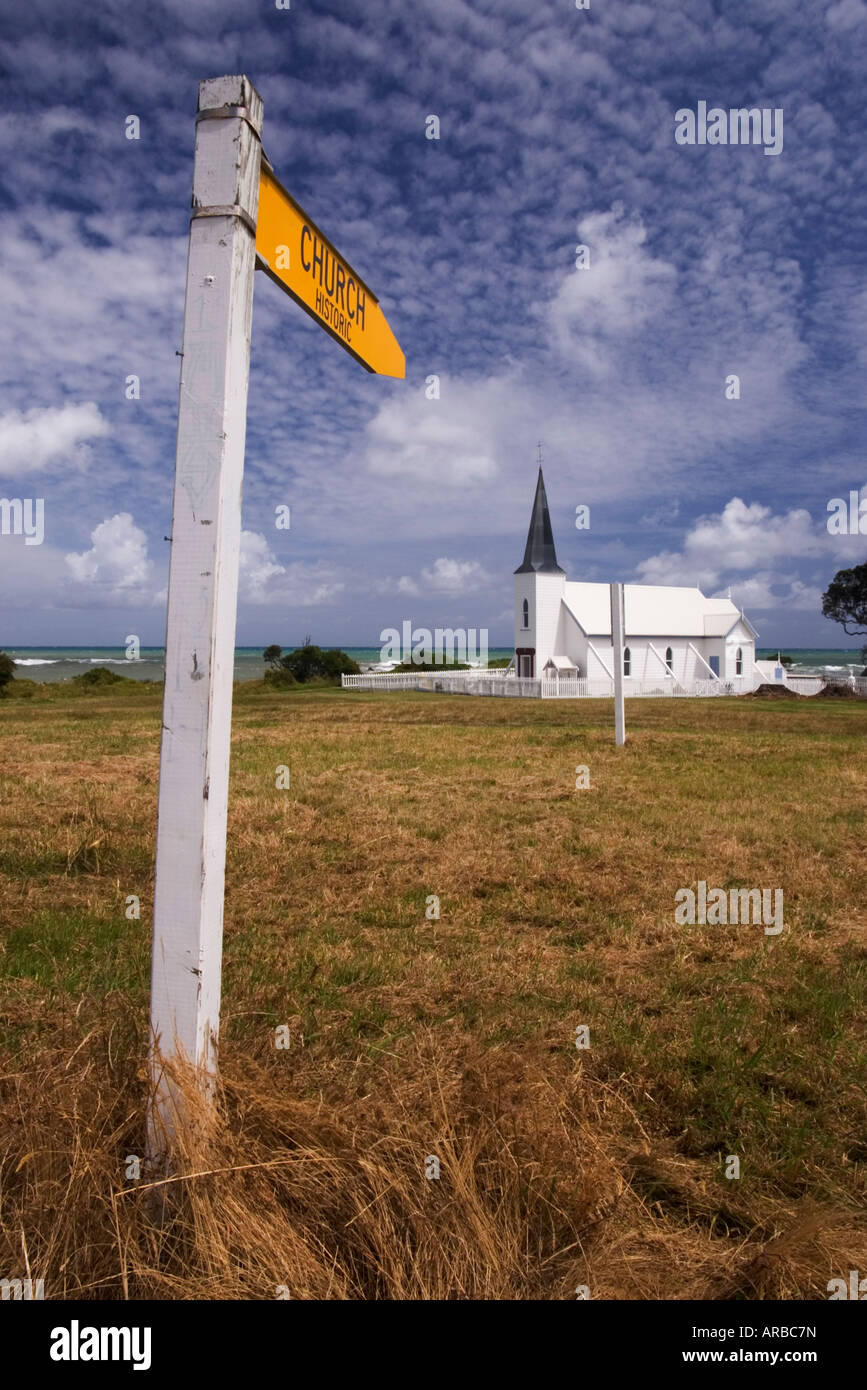 A sign by the road indicates that this isolated church is historic. Raukokore on East Coast of New Zealand's North Island Stock Photo