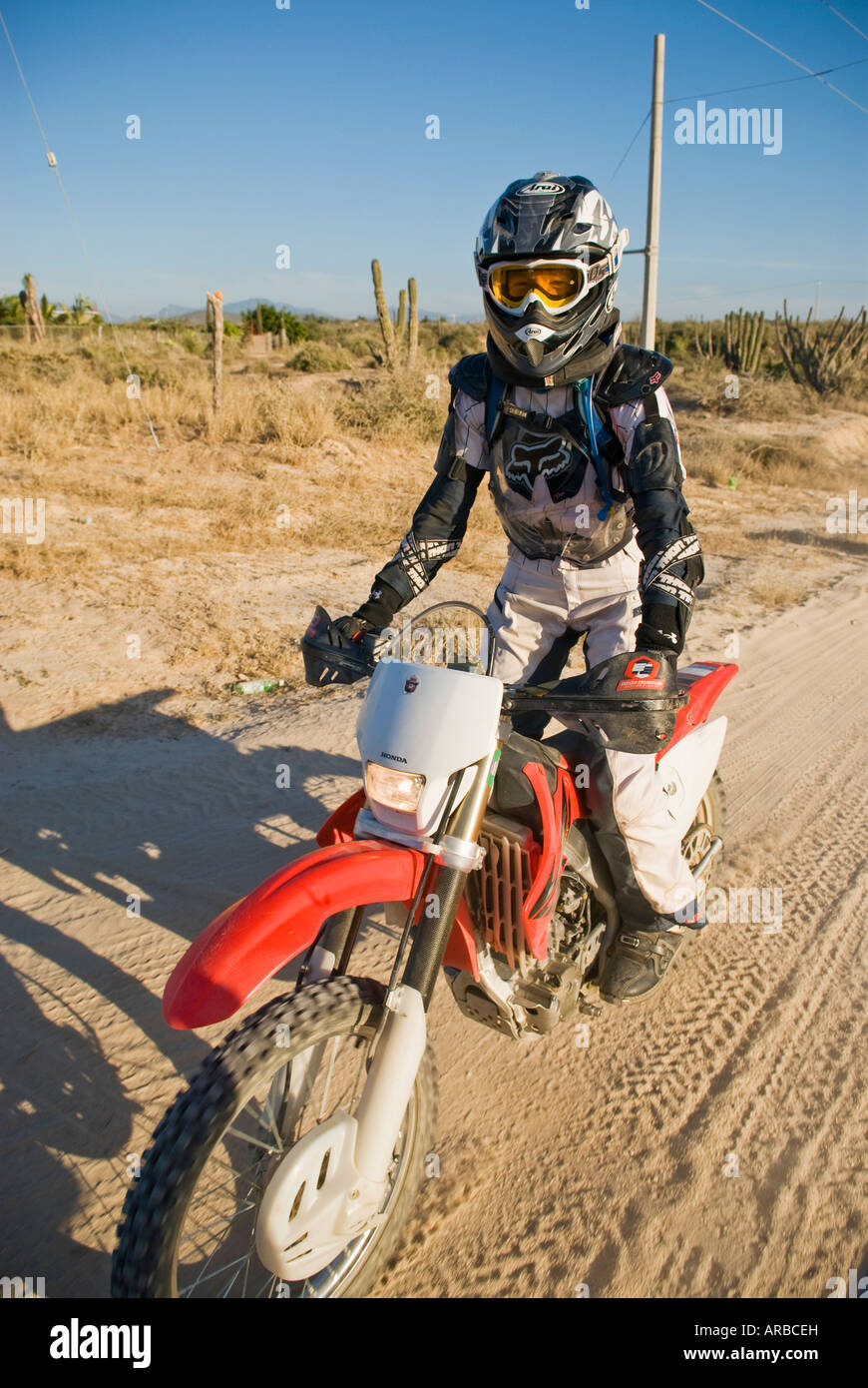 mature adult female off road motorcycle rider on dirt road north of Todos Santos, Baja California, Mexico Stock Photo