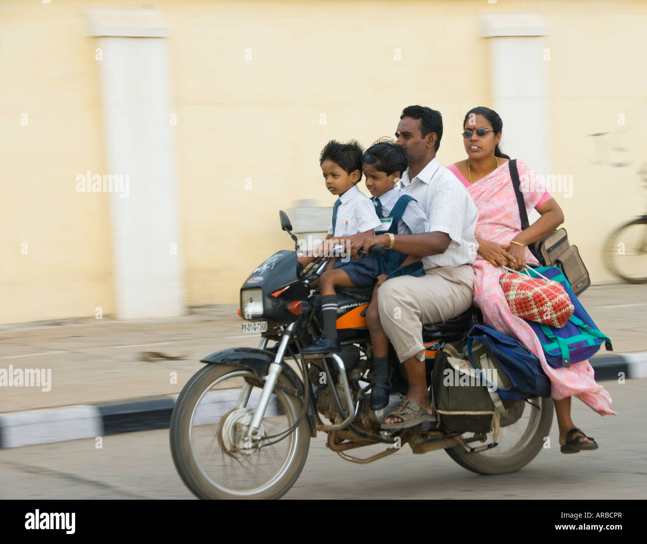 An Indian family on a motorbike in India. Ratan Tata has said seeing whole famiies on one bike was his inspiration for the Nano Stock Photo