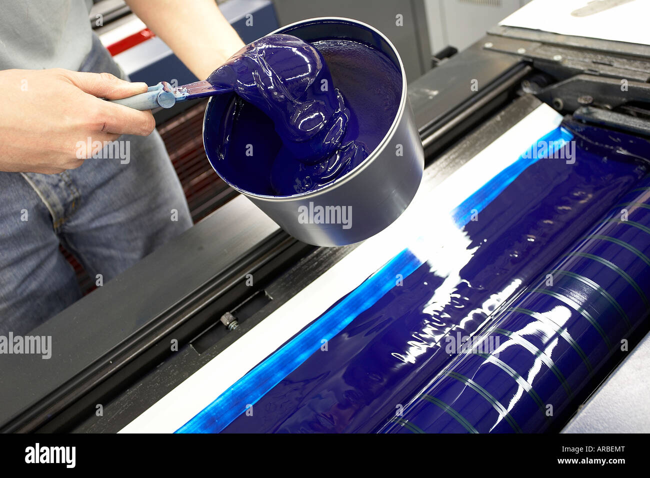 INKING A PRINTING PRESS BLUE ROLLER Stock Photo Alamy