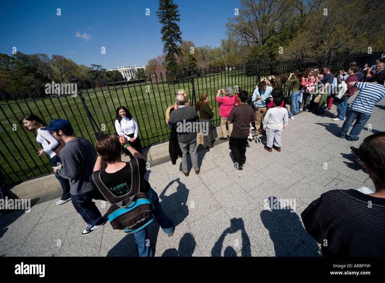 Springtime view of the rear of the White House with tourists taking pictures through the fence. Stock Photo