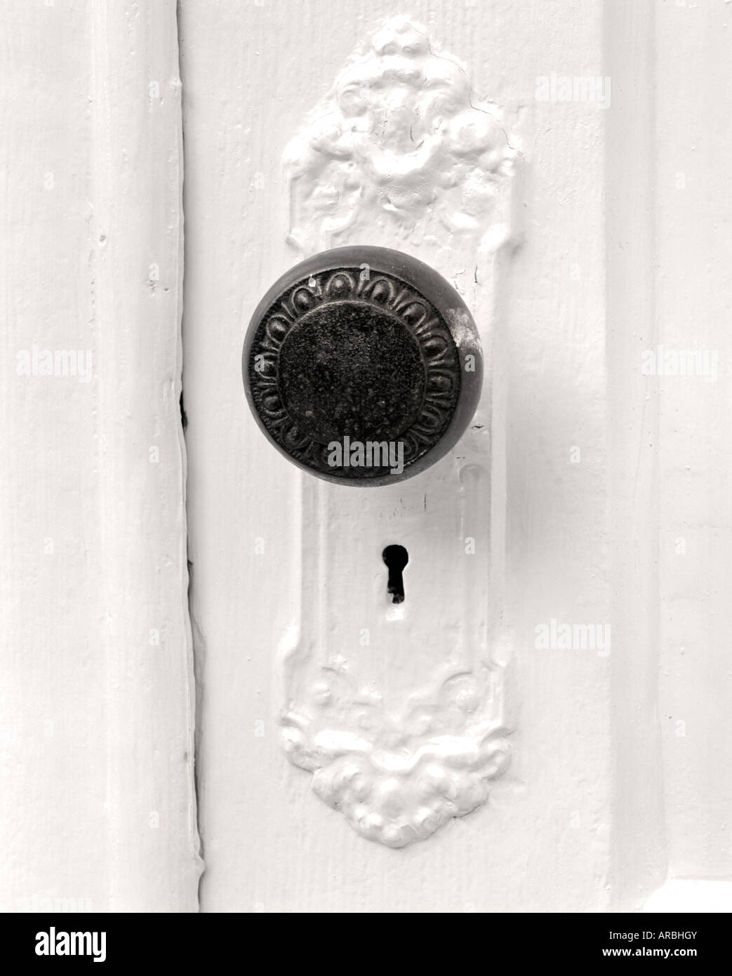 old antique door knob on white door Stock Photo