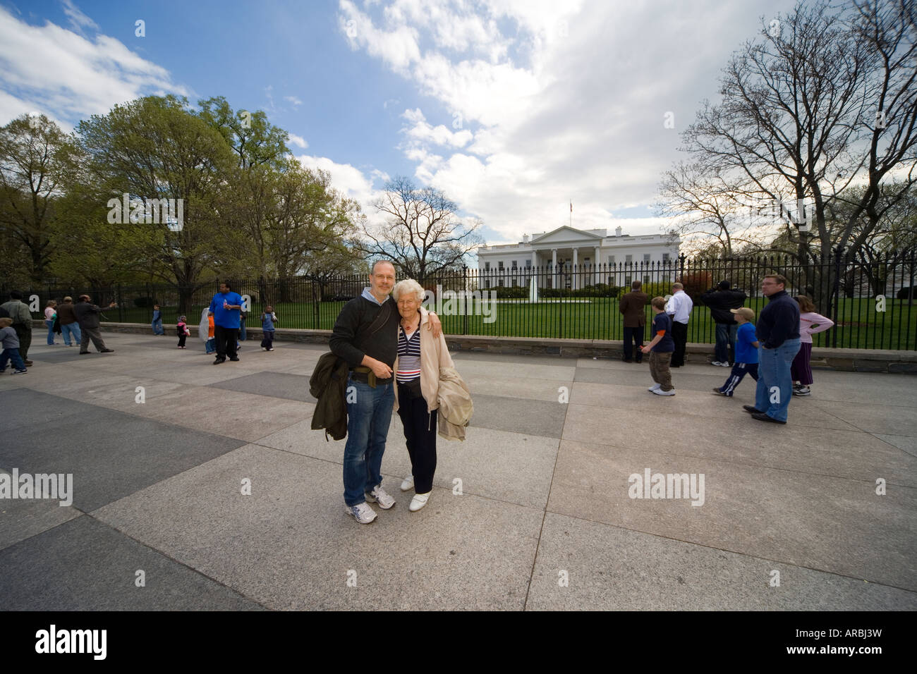 Elderly tourists from Europe posing in front of the White House, Penn Ave Washington DC. Stock Photo