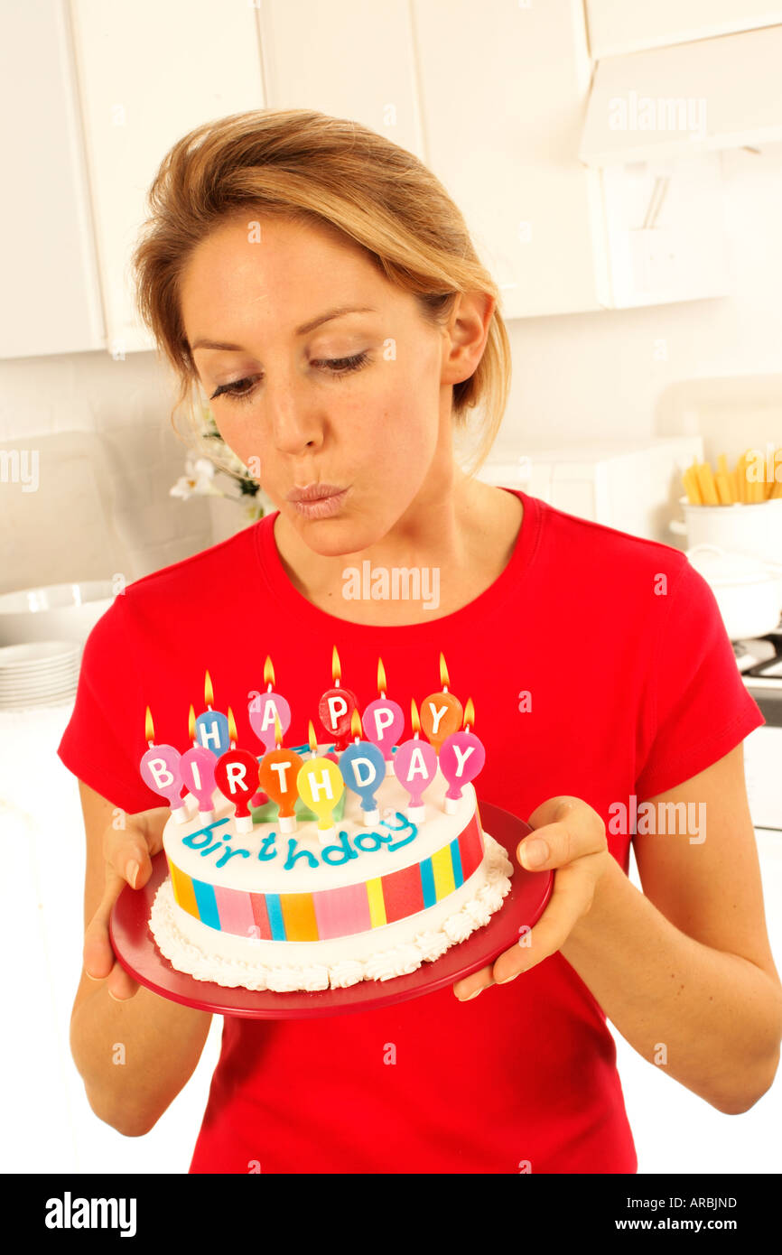 GIRL WITH BIRTHDAY CAKE BLOWING OUT CANDLES Stock Photo Alamy