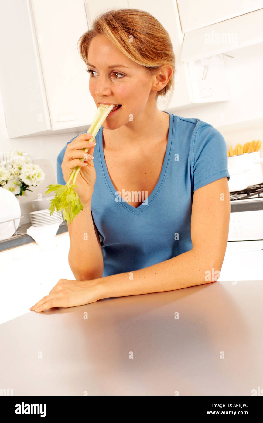 GIRL EATING STICK OF CELERY Stock Photo Alamy