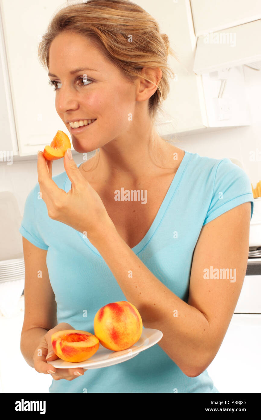 GIRL EATING NECTARINES Stock Photo Alamy