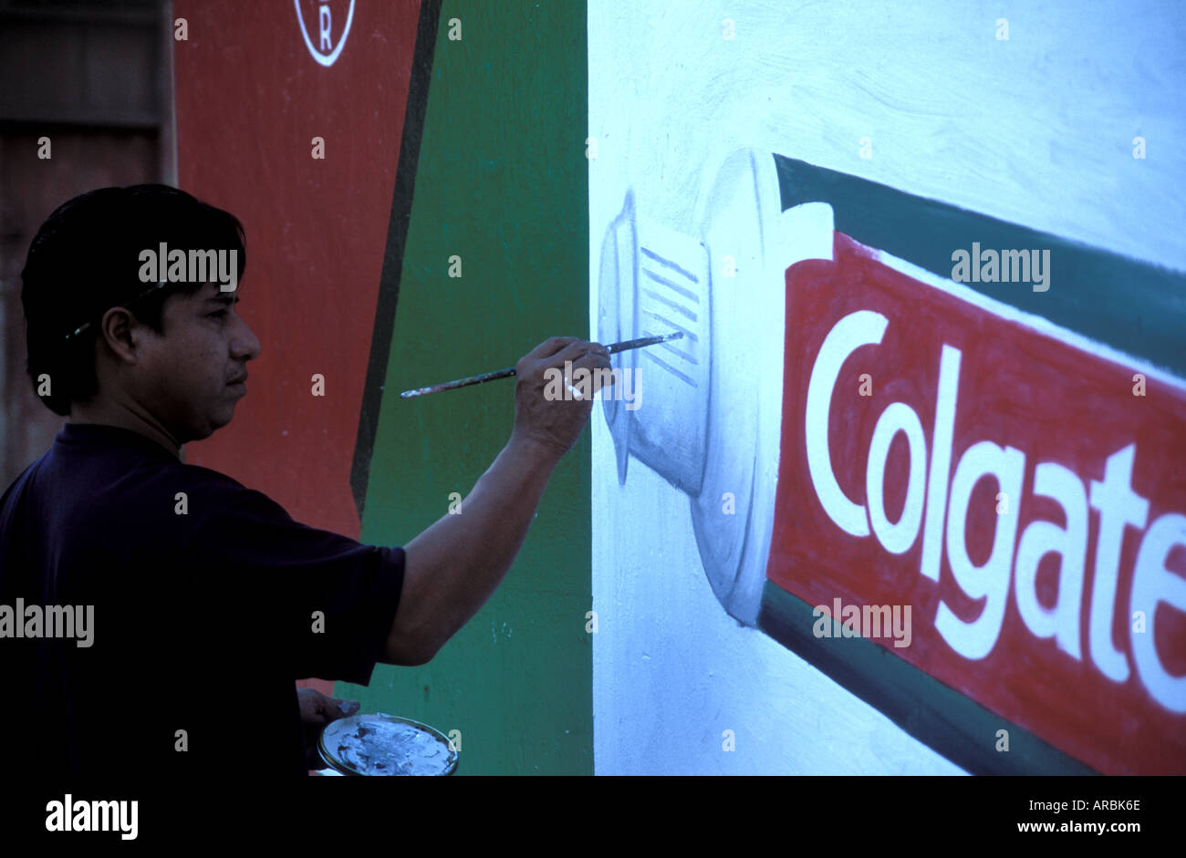 Artist painter painting colgate commercial advertisement poster on housewall Matagalpa Nicaragua Stock Photo