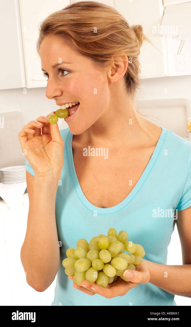 GIRL EATING GRAPES Stock Photo - Alamy