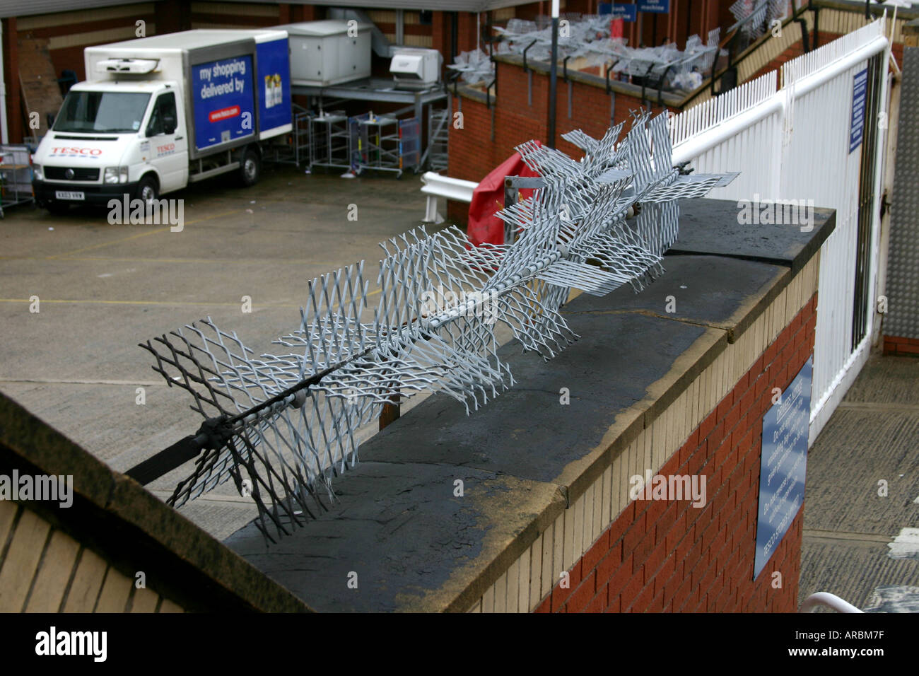 Rotating steel blades on a wall top to deter access by thieves Stock Photo Alamy