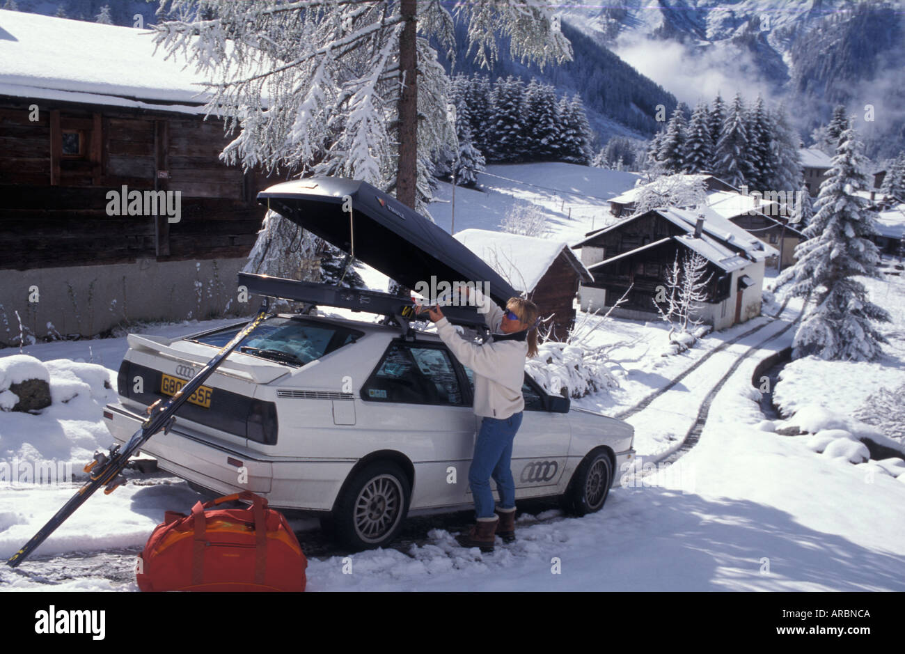 Woman Unloading The Ski Box On Top Of A Car In A Ski Resort Stock Photo Alamy