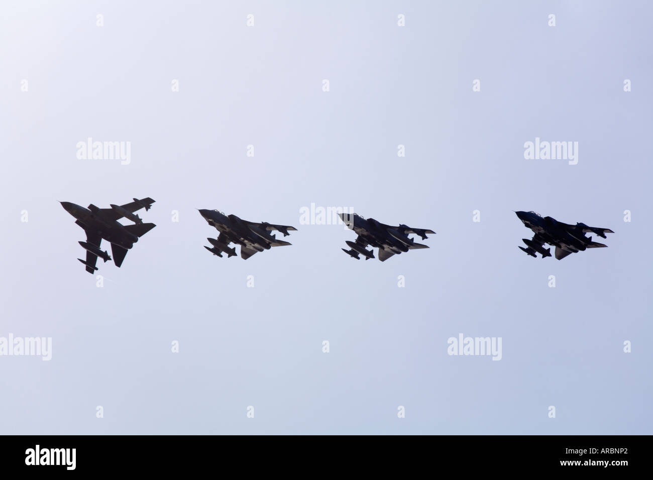 4 RAF Tornado GR4 aircraft from 617 Squadron in silhouette Stock Photo