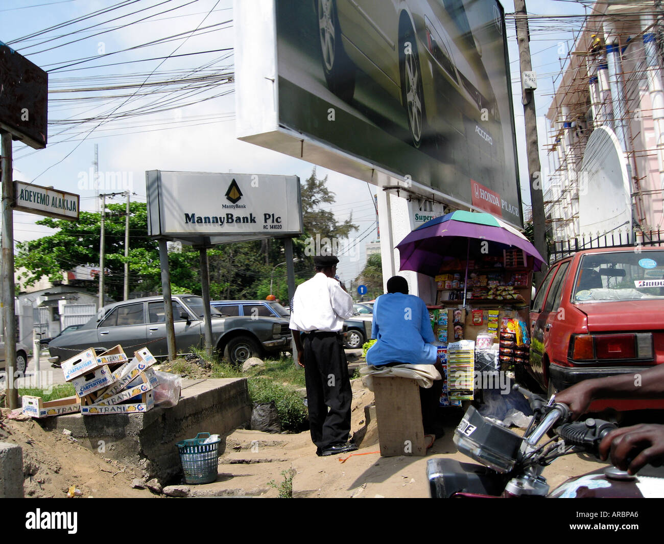 Typical street scene, Lagos, Nigeria. Roadside stalls as there are few
