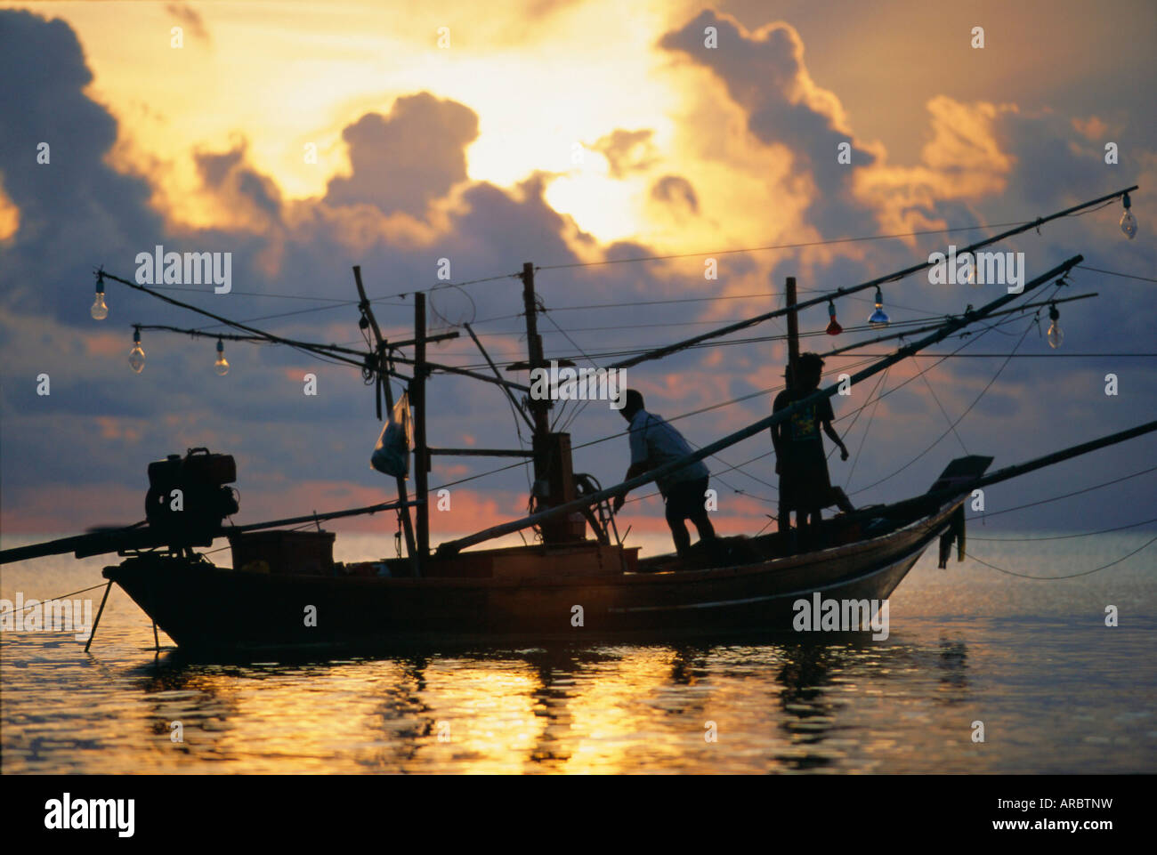 Fishing boat at sunrise at Haad Rin Beach, Koh Pha Ngan, Thailand Stock Photo
