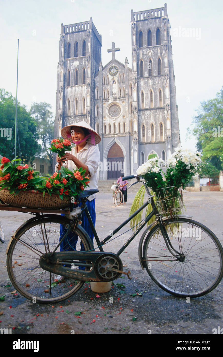 Woman selling flowers off her bicycle, Hanoi, Vietnam, Indochina, Asia Stock Photo