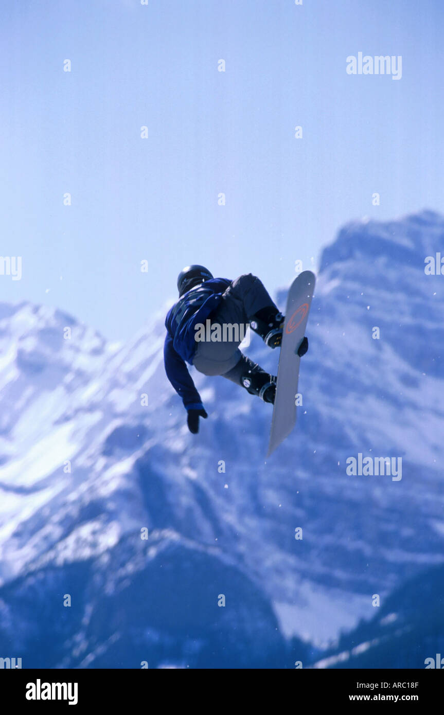 Snowboarder performing grab at big air competition in Canada Stock Photo