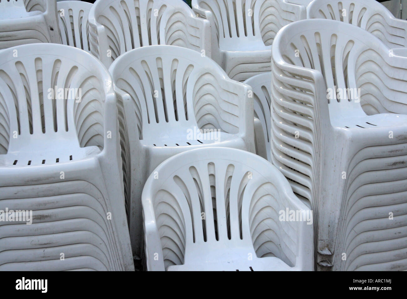 white plastic stacking chairs stock photo  alamy