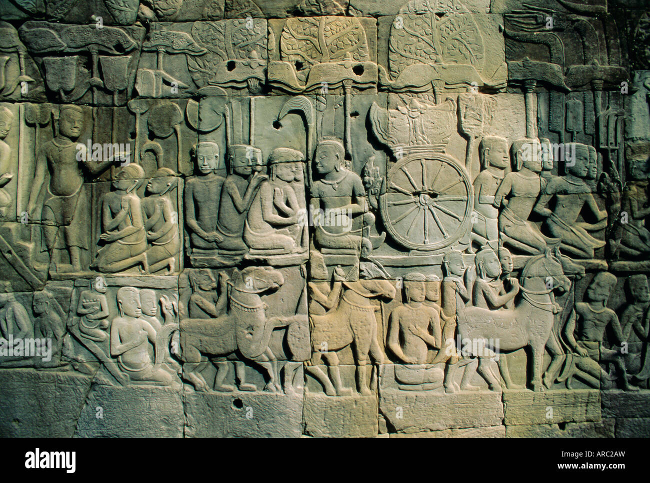 Stone bas-reliefs depicting scenes of rural life and historical events, in the Bayon Temple complex, Angkor, Siem Reap, Cambodia Stock Photo