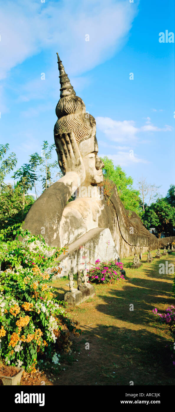 Reclining Buddha statue in the open at Xieng Khuan, Vientiane, Laos Stock Photo