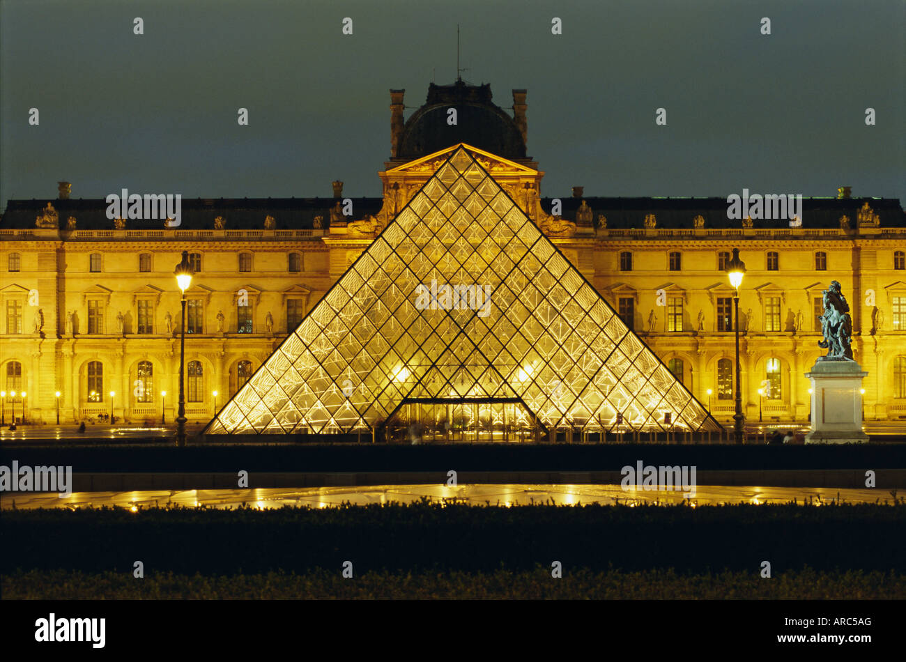 The Louvre and pyramid illuminated at night, Paris, France, Europe Stock Photo