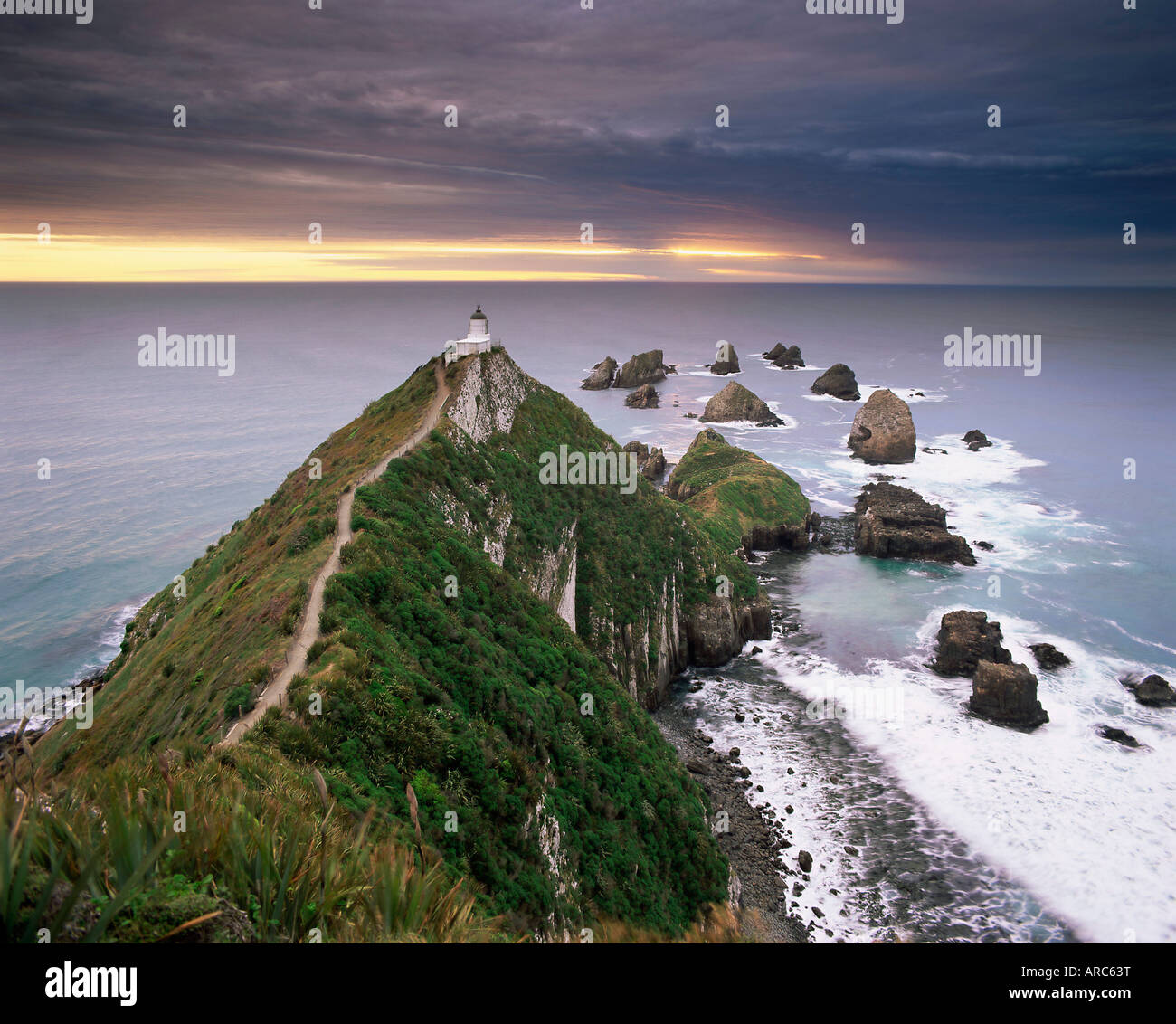 Nugget Point lighthouse on the coast and overcast sky, the Catlins, South Island, New Zealand, Pacific Stock Photo