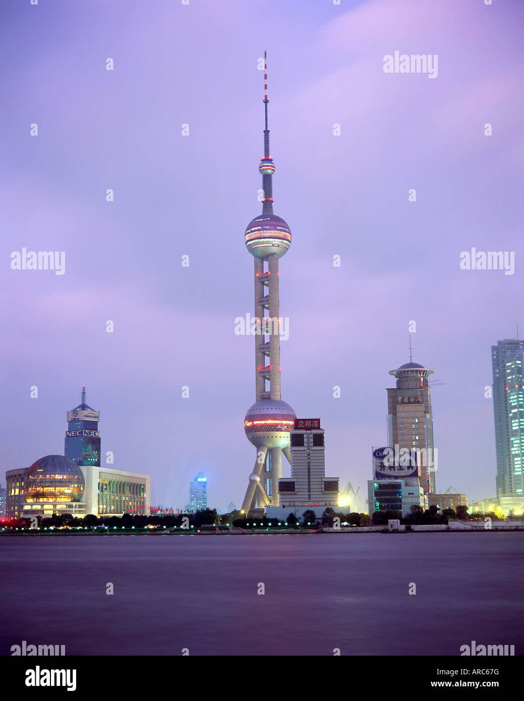 View across river at dusk to the new Pudong district skyline, Huangpu River, Shanghai, China, Asia Stock Photo