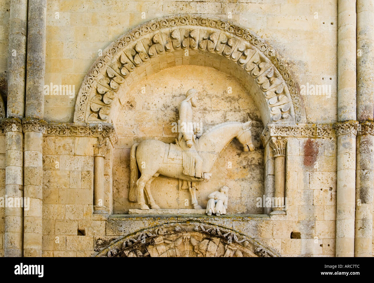 Carving of horseman, known as le cavalier de Melle,  above the north doorway to the church of St Hilaire Melle Poitou France Stock Photo