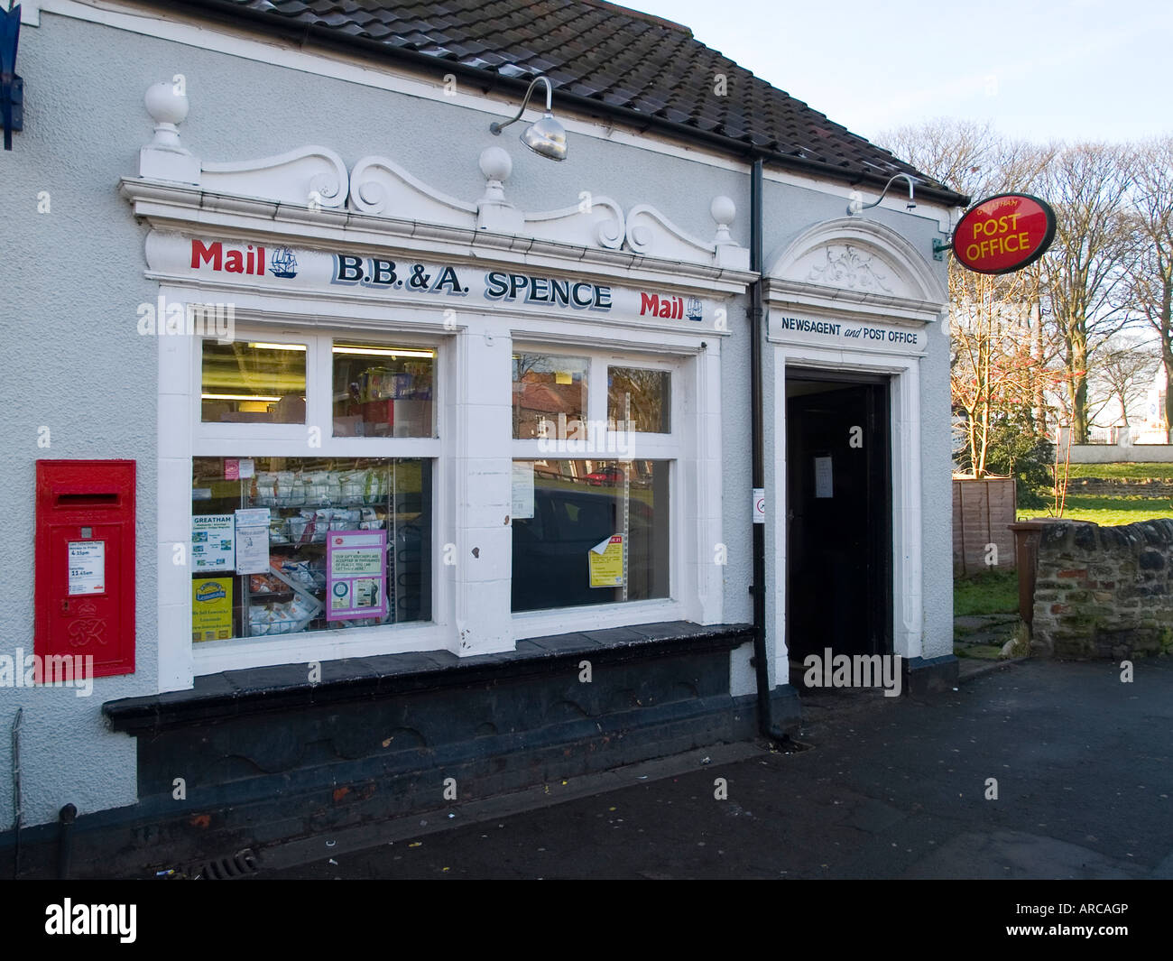 A small newsagent shop and post office with a decorated plaster front
