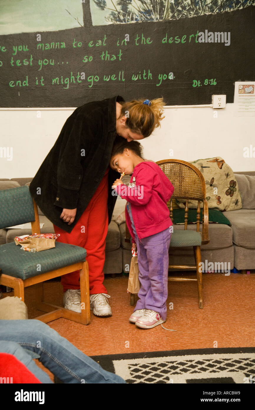 A Volunteer Hugs A Local Child During Christmas Activities For Low Income And Homeless Locals At A Homeless Shelter In Barstow C Stock Photo Alamy