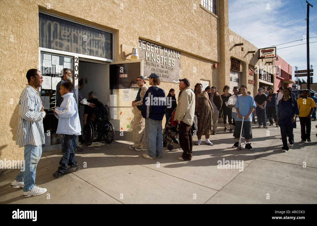 A couple line up for a free Christmas dinner at a homeless shelter in