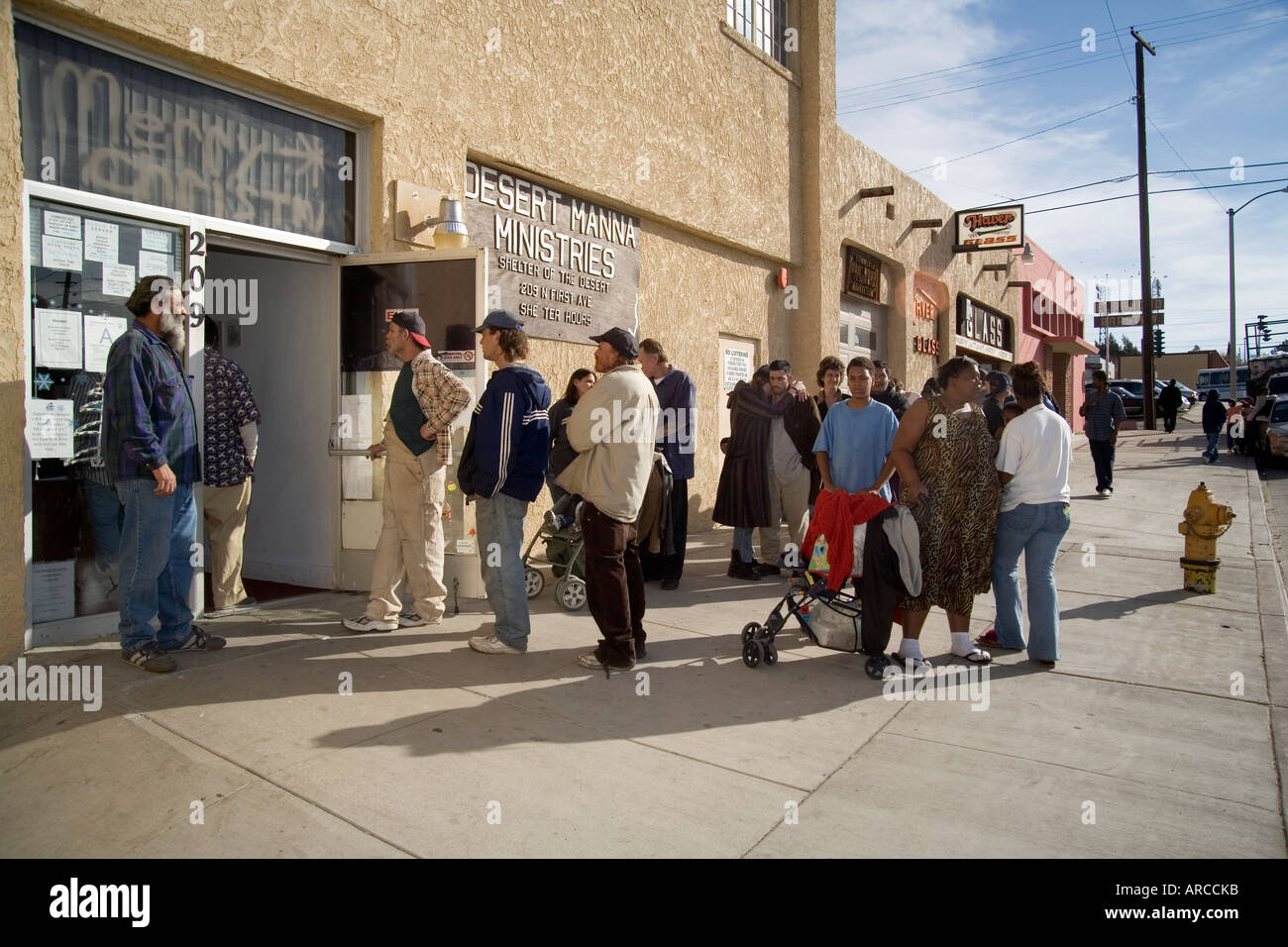 A couple line up for a free Christmas dinner at a homeless shelter in
