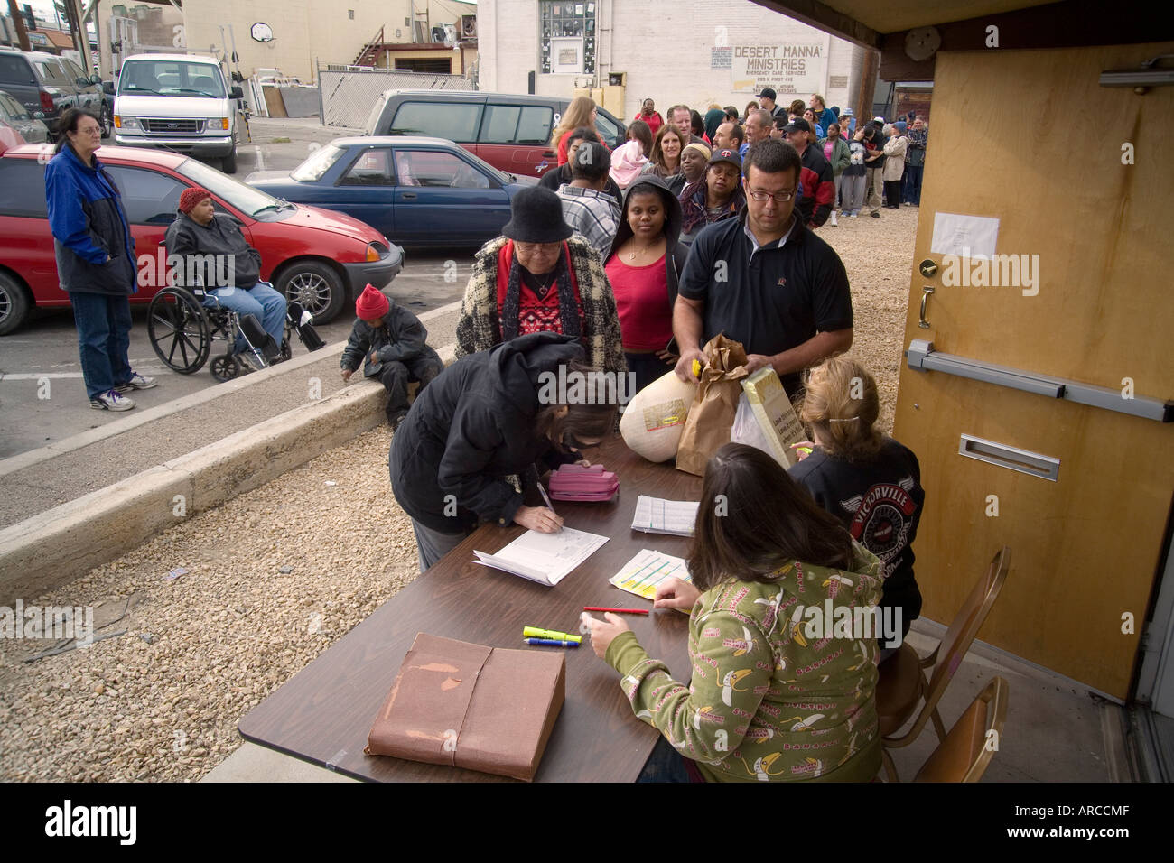 Low and homeless people line up at a Barstow CA homeless shelter