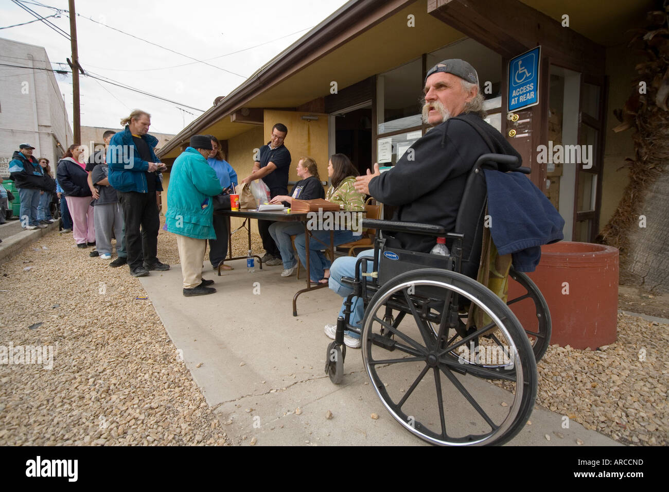 Low and homeless people line up at a Barstow CA homeless shelter