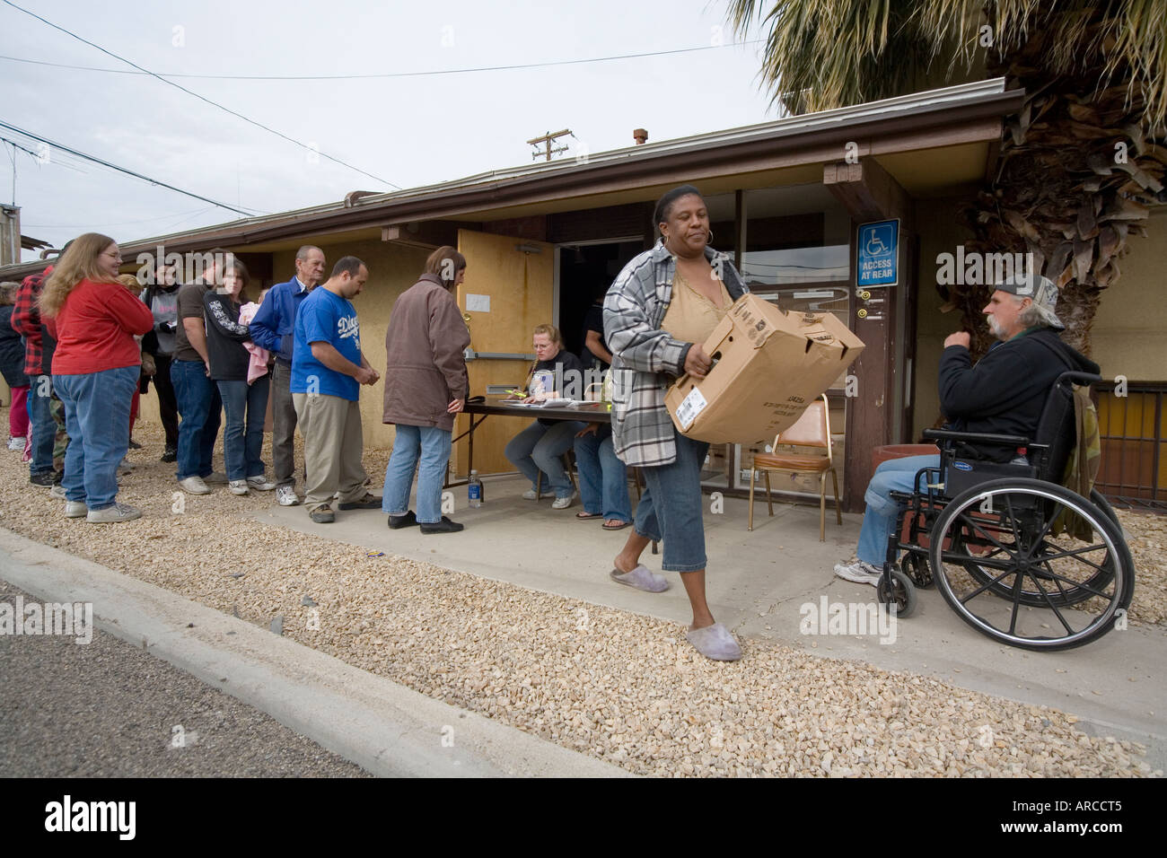 Low and homeless people line up at a Barstow CA homeless shelter