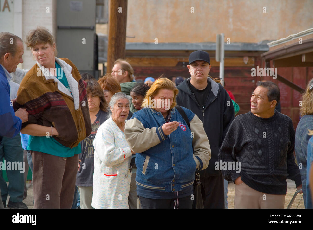 Low and homeless people in Barstow CA line up at a homeless