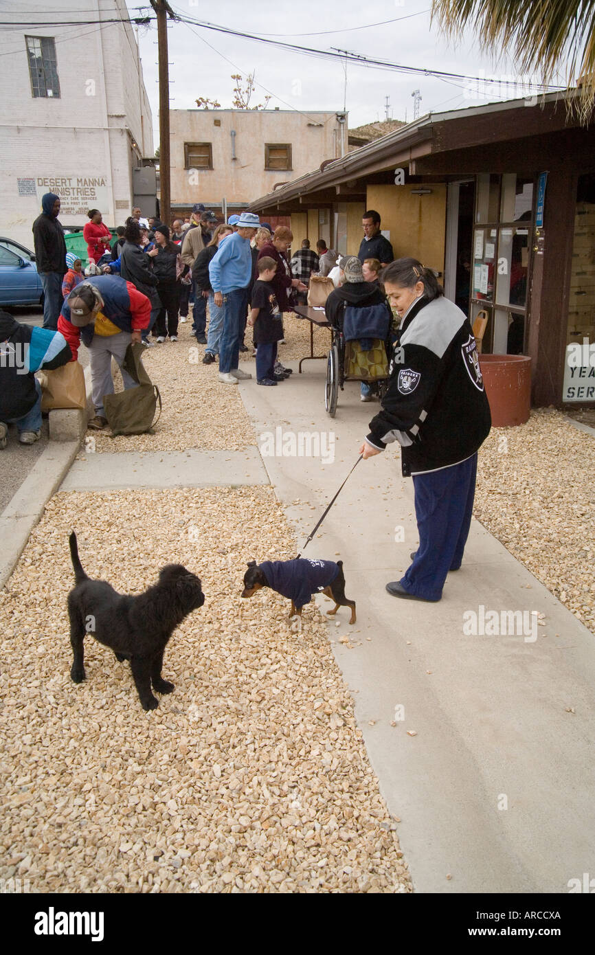 Low and homeless people in Barstow CA line up at a homeless
