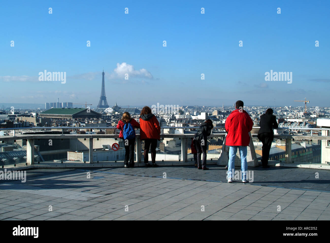 Paris skyline view from Galeries Lafayette store rooftop exterior public viewing area Eiffel Tower distant on cold winter sunny blue sky day in France Stock Photo