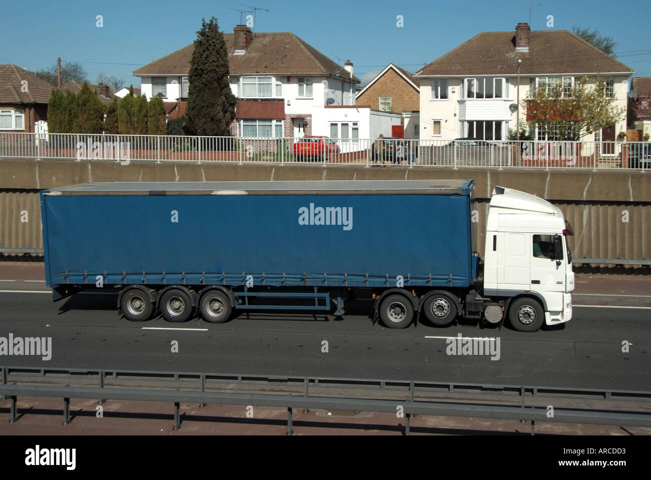 Unmarked lorry truck dual carriageway A12 trunk road close to residential homes suffering noise & air pollution from heavy traffic Essex England UK Stock Photo