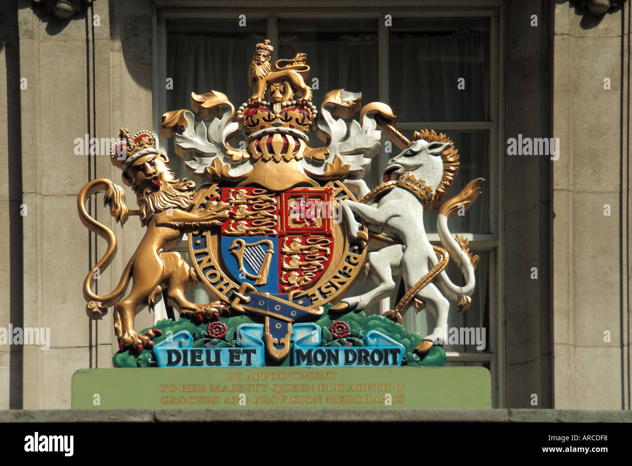Fortnum & and Mason close up of Royal Warrant crest above entrance in Piccadilly awarded to this large upmarket retail food store business London UK Stock Photo