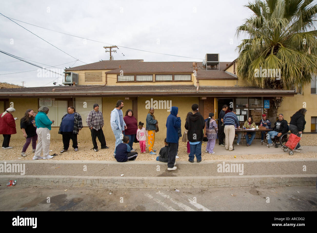 Low and homeless people line up at a Barstow CA homeless shelter