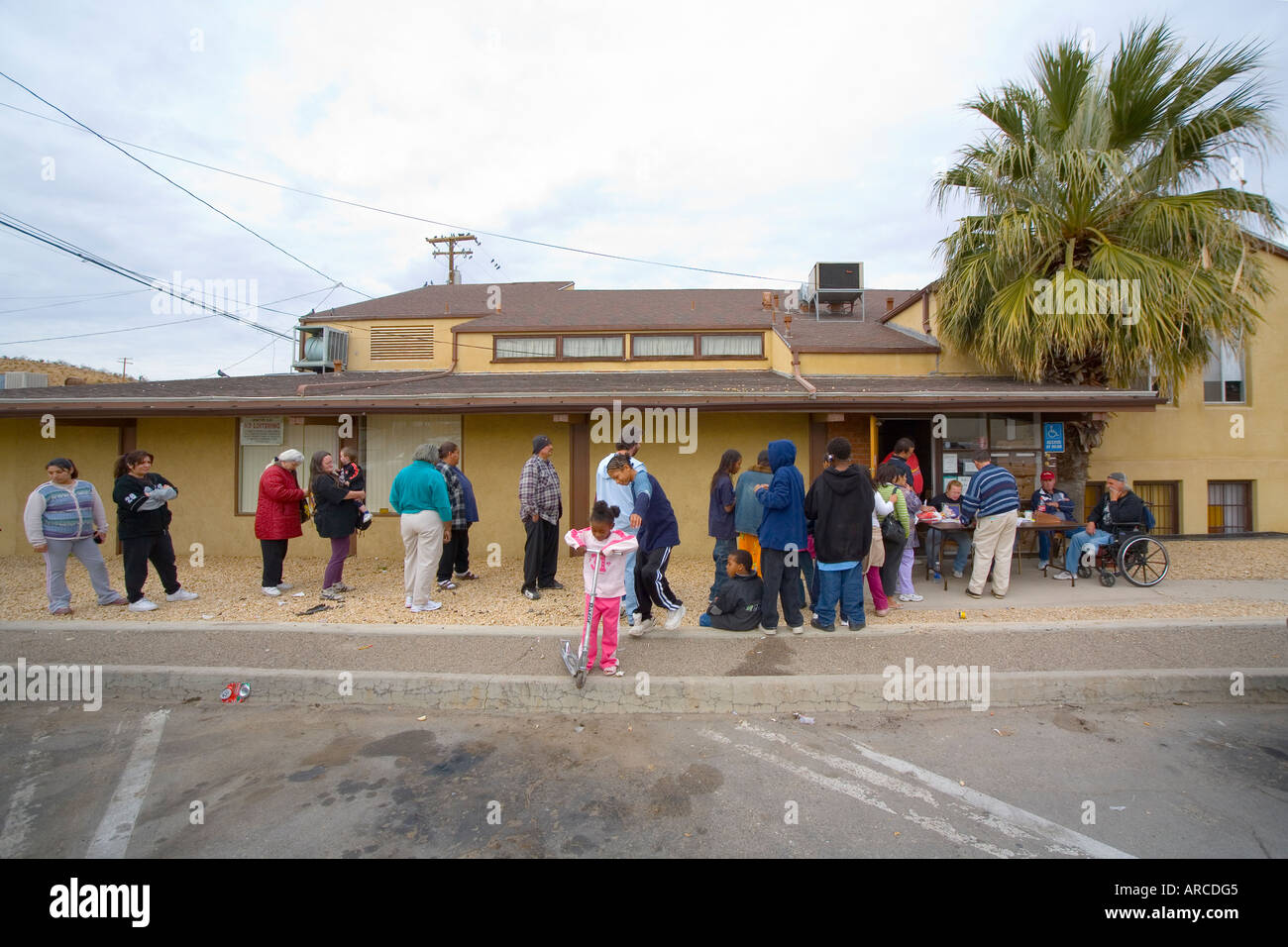 Low and homeless people line up at a Barstow CA homeless shelter