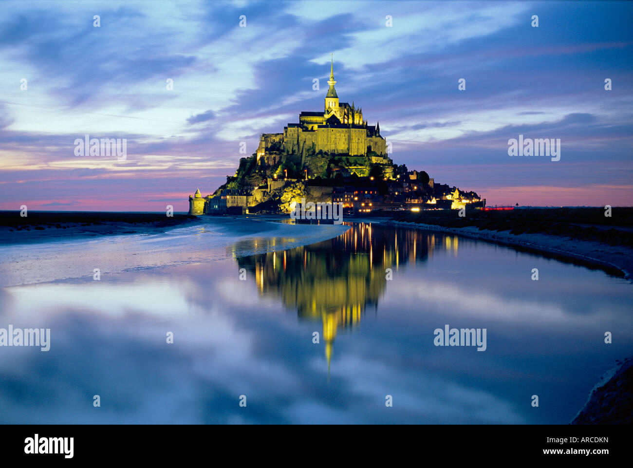 The mount by night reflected in water, Mont St Michel, Manche, Normandy, France Stock Photo