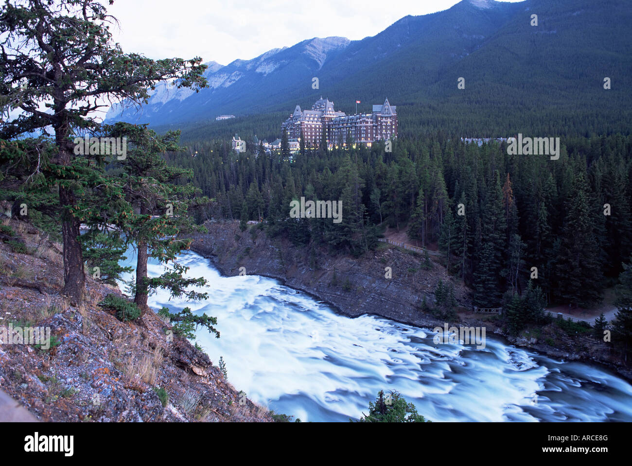 Banff, the Bow Falls and prestigious Banff Springs Hotel, at dusk, Banff National Park, Alberta, Canada Stock Photo