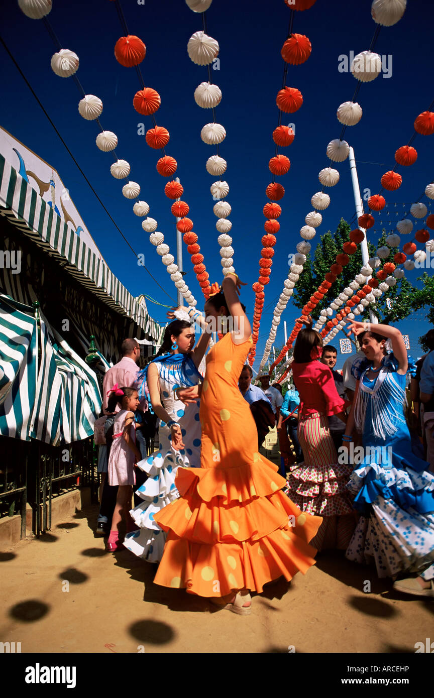 Girls dancing a sevillana beneath colourful lanterns, Feria de Abril (April Fair), Seville, Andalucia (Andalusia), Spain, Europe Stock Photo