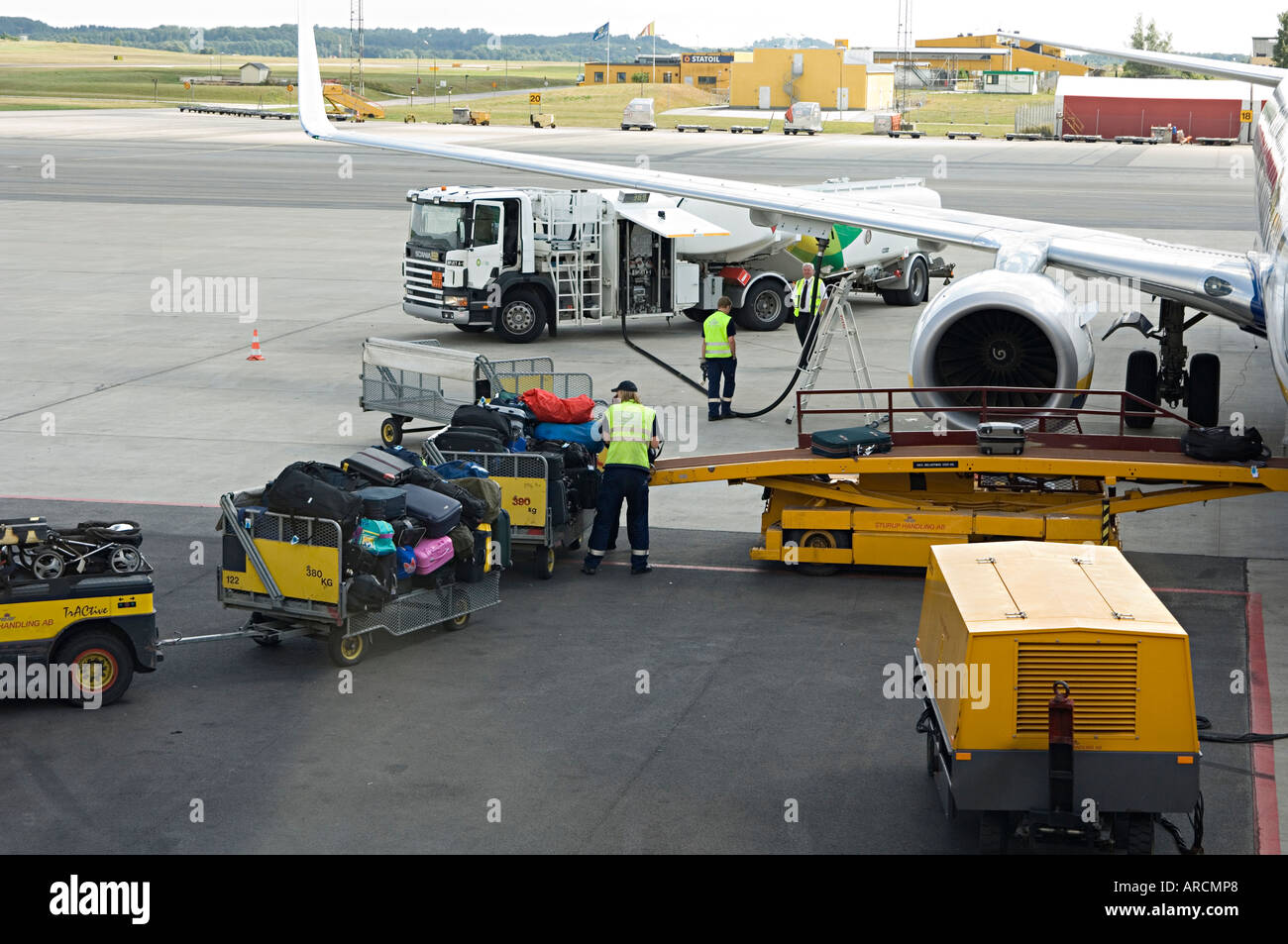 Loading the passengers' luggage onto an airplane Stock Photo