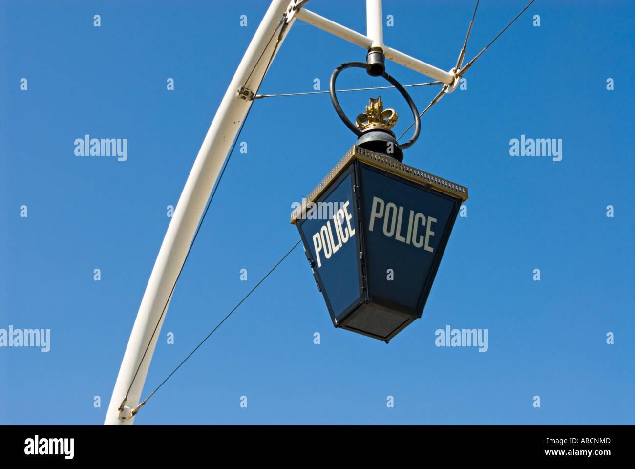 A traditional blue lamp suspended outside a police station Stock Photo